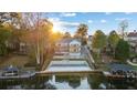 Backyard featuring a multi-tiered landscape design leading to the lake, complete with boat docks and a serene view at 9058 Woodlake Lane, Villa Rica, GA 30180