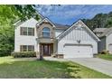 Attractive two-story home with a well-maintained lawn and an attached two-car garage at 2020 Walking Horse Trl, Cumming, GA 30041