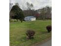 Detached garage in a spacious yard; perfect for storage or a workshop at 2620 Dr Bramblett Rd, Cumming, GA 30028
