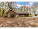 Charming single-story brick home surrounded by mature trees and a spacious front yard at 2775 Hogan Rd, Atlanta, GA 30344