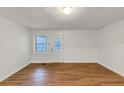 Bright living room features wood flooring, fresh white paint, and a door with glass inset at 2775 Hogan Rd, Atlanta, GA 30344