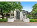Elegant condo building featuring a grand entrance, mature trees, and beautifully landscaped grounds at 3304 Pine Heights Ne Dr, Atlanta, GA 30324