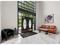 Spacious foyer featuring soaring ceilings, modern lighting, sleek marble floors, and stylish contemporary furniture at 3304 Pine Heights Ne Dr, Atlanta, GA 30324