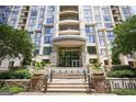 Elegant building entrance with stone accents, manicured landscaping, and a welcoming water feature at 3445 Stratford Rd # 1501, Atlanta, GA 30326
