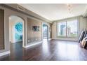 A bright and airy living room with hardwood floors and a large window offering city views at 3445 Stratford Rd # 1501, Atlanta, GA 30326