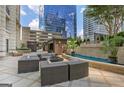Luxurious outdoor lounge area with comfortable seating, a cozy fireplace, and a calming water feature at 3445 Stratford Rd # 1501, Atlanta, GA 30326