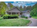 Beautiful single-story home featuring a charming covered porch and well-manicured lawn at 160 Riverbrooke Trl, Covington, GA 30016