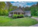 Beautiful single-story home featuring a charming covered porch and well-manicured lawn at 160 Riverbrooke Trl, Covington, GA 30016