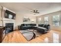 Bright living room with fireplace, hardwood floors, and a large sectional couch at 1928 Stancrest Nw Trce, Kennesaw, GA 30152