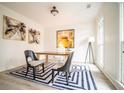 Well-lit home office with a large window, modern decor, and stylish furnishings at 21 Whitegrass Way, Grayson, GA 30017