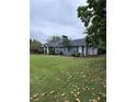 Lovely ranch home with attached garage, featuring a well-maintained lawn and mature trees at 4925 Happy Hollow Rd, Dunwoody, GA 30360