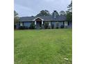 Charming one-story home with manicured lawn and mature trees in a quiet neighborhood at 4925 Happy Hollow Rd, Dunwoody, GA 30360