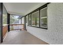 View of the home's porch, showing white painted brick, black trim, and wood railings at 644 Church Nw St, Atlanta, GA 30318