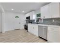 Modern kitchen with white cabinets, stainless steel appliances, and stylish backsplash at 644 Church Nw St, Atlanta, GA 30318