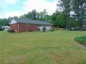 Expansive backyard with a lush lawn, bordered by mature trees, offering privacy at 126 Brittany Dr, Canton, GA 30115