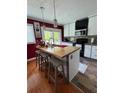 Kitchen features an island with seating, modern appliances, and ample cabinet space at 126 Brittany Dr, Canton, GA 30115