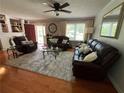 Cozy living room with hardwood floors, ceiling fan, and comfortable seating at 126 Brittany Dr, Canton, GA 30115