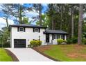 A charming house with a well manicured lawn and driveway offers great curb appeal at 1934 Glen Echo Dr, Decatur, GA 30032