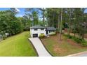 Aerial view of charming two-story home with mature trees and a long driveway at 1934 Glen Echo Dr, Decatur, GA 30032