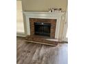 Close up of the living room brick fireplace, with a white mantle and hearth at 432 Manor Estates Dr, Stockbridge, GA 30281