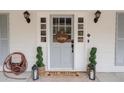 Welcoming front door with decorative wreath and dog-friendly mat at 762 Thompson Ln, Loganville, GA 30052