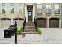 Inviting townhouse with brick facade, featuring a charming entryway and front lawn at 9056 Riverbend Mnr, Alpharetta, GA 30022