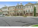Attractive townhomes with brick exteriors, attached garages, and manicured front yards at 9056 Riverbend Mnr, Alpharetta, GA 30022