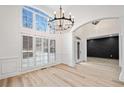 Bright entryway showcasing modern chandelier, wainscoting, and large windows at 1007 Fairway Seven, Villa Rica, GA 30180
