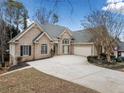 Beautiful brick home featuring an attached two-car garage and expansive driveway at 1007 Fairway Seven, Villa Rica, GA 30180