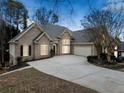 Beautiful brick home featuring an attached two-car garage and expansive driveway at 1007 Fairway Seven, Villa Rica, GA 30180