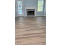 Inviting living room features new wood floors, a cozy fireplace, natural light, and an easy access to backyard patio at 5683 Isleworth Way, Atlanta, GA 30349