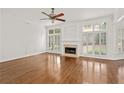 Bright living room features a fireplace and hardwood floors at 5725 Lake Oak Lndg, Cumming, GA 30040