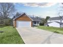 Exterior side view of home and long driveway leading to the attached two car garage at 6057 Dorchester Dr, Rex, GA 30273