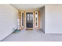 Covered front porch and front door of home with views of the front yard at 6057 Dorchester Dr, Rex, GA 30273