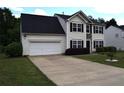 Classic two-story home with a two-car garage and traditional landscaping at 1371 Blazing Star Rd, Lawrenceville, GA 30045