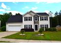 Beautiful two-story home featuring a well-kept lawn and a two-car garage at 1371 Blazing Star Rd, Lawrenceville, GA 30045