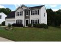 Charming two-story home featuring a well-manicured lawn and an attached two car garage at 1371 Blazing Star Rd, Lawrenceville, GA 30045