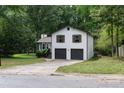 Side view of a well maintained home with a driveway leading to an attached garage at 2442 Falcon Ct, Lawrenceville, GA 30043