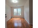 Bright bedroom with hardwood floors and large window at 282 Ellesmere Court, Buford, GA 30518