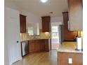 Modern kitchen featuring stainless steel appliances, granite countertops, and ample cabinet space at 282 Ellesmere Court, Buford, GA 30518