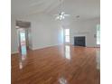 Spacious living room with hardwood floors, fireplace, and ceiling fan at 282 Ellesmere Court, Buford, GA 30518