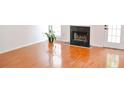 Bright living room features shiny hard wood floors, fireplace and large windows at 282 Ellesmere Court, Buford, GA 30518