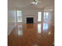 Bright living room with hardwood floors, fireplace, and natural light from the front door at 282 Ellesmere Court, Buford, GA 30518