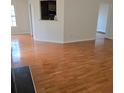 Open-concept living room with hardwood floors, neutral paint and sightlines into the kitchen beyond at 282 Ellesmere Court, Buford, GA 30518
