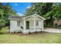 Quaint home with a welcoming front porch and swing, nestled in a green, leafy neighborhood at 376 Pine Ne St, Marietta, GA 30060