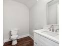 Clean and modern powder room featuring a white vanity and updated fixtures at 8210 Sonata Ln, Cumming, GA 30041