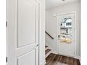 Bright entryway with hardwood floors, white trim, and a view of the front exterior at 8210 Sonata Ln, Cumming, GA 30041