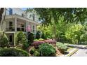 Scenic view of a home with a welcoming porch and vibrant, well-maintained landscaping at 6715 Pond Rd, Cumming, GA 30040