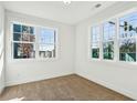 Sunlit bedroom with neutral carpet, fresh white paint, and large windows at 101 Mission Se Way # 101, Atlanta, GA 30315
