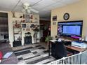 Open living area features a flat screen TV, shelving, and view of the kitchen at 2195 Wilson Rd, Conyers, GA 30012